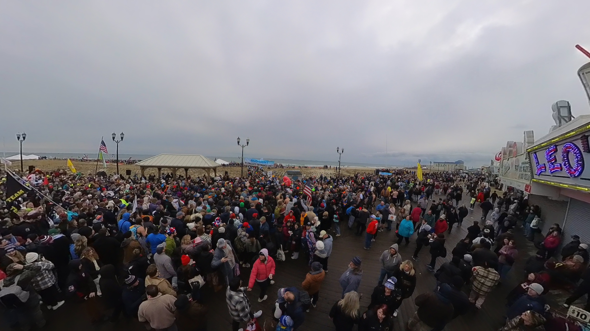 Boardwalk view of 1000s of people entering beach for Seaside Heights Polar Bear Plunge 2024